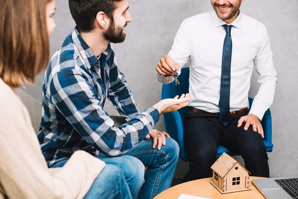 crop-couple-taking-keys-from-agent_23-2147797652
